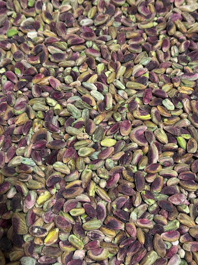 Close-up of shelled Afghan pistachios (pista giri) showing natural purple-to-green skins — Ghafori Foods