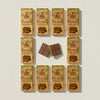 Box of 10 Barlo Dubai Chocolate with Pistachio 100g bars laid out, with two squares showing the pistachio filling — Ghafori Foods