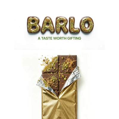 Opened Barlo Dubai Chocolate bar in gold foil with pistachio pieces and kadayif threads on top — Ghafori Foods